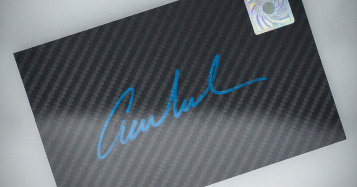 Certified autograph sports card with a player's blue ink signature across a glossy card surface and an authentication hologram on the reverse